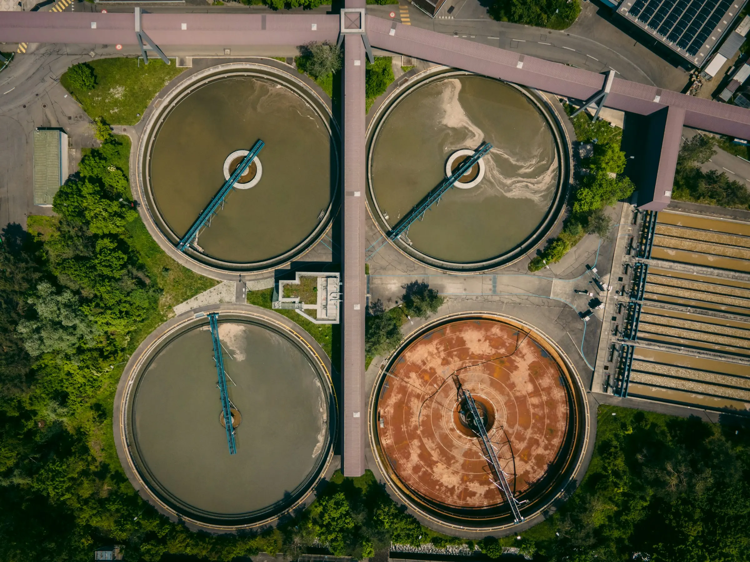 An aerial view of round clarifier tanks at a wastewater treatment plant